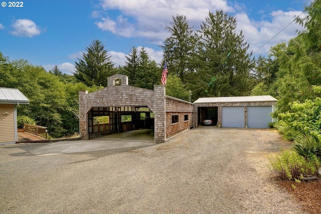 view of front of property with an outdoor structure and a garage