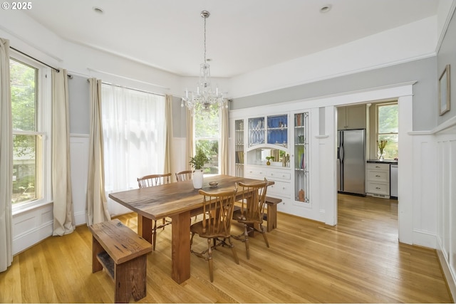 2147 NE 14th Ave, Portland, OR 97212 - dining space featuring a chandelier, light wood-style floors, and plenty of natural light