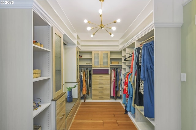 2147 NE 14th Ave, Portland, OR 97212 - walk in closet featuring wood finished floors and a chandelier