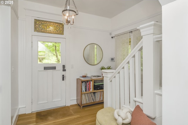 2147 NE 14th Ave, Portland, OR 97212 - foyer entrance featuring wood finished floors, a chandelier, and stairs