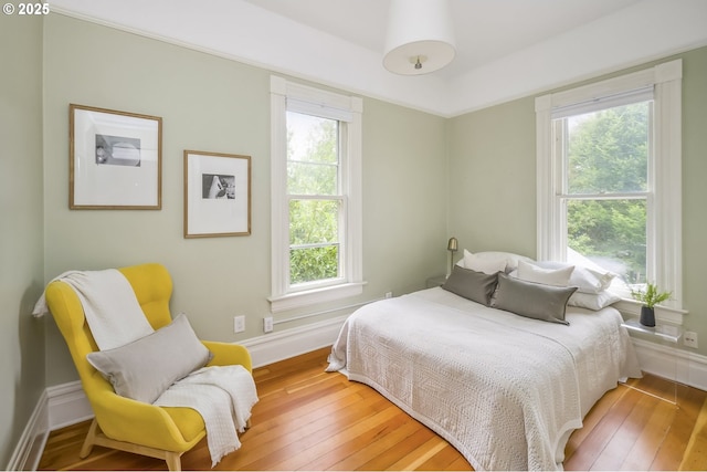 2147 NE 14th Ave, Portland, OR 97212 - bedroom featuring multiple windows, light wood-style flooring, and baseboards