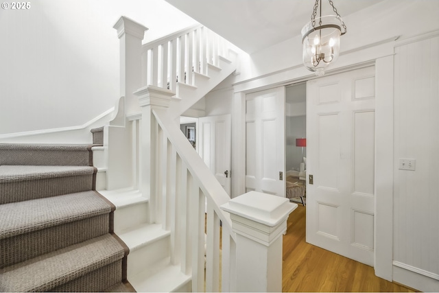 2147 NE 14th Ave, Portland, OR 97212 - stairway with wood finished floors and a chandelier
