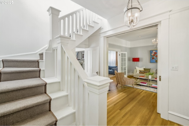 2147 NE 14th Ave, Portland, OR 97212 - stairs featuring wood finished floors and a chandelier