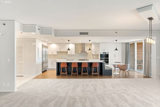 kitchen with white cabinets, a kitchen island, tasteful backsplash, and pendant lighting