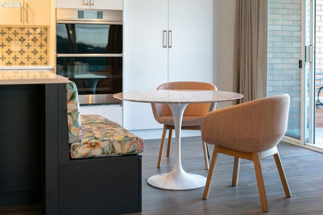 dining space with hardwood / wood-style floors