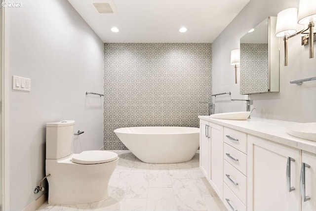 bathroom featuring double sink, tile walls, tile floors, vanity with extensive cabinet space, and toilet