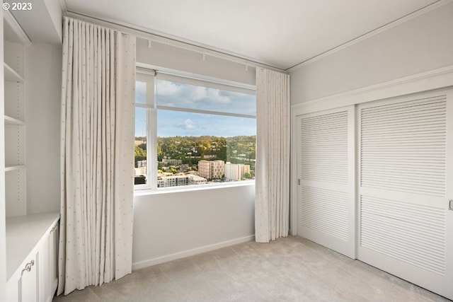 unfurnished bedroom featuring a closet and light carpet