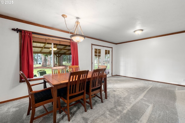 dining area featuring carpet floors, a wealth of natural light, and french doors