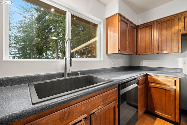 kitchen featuring light hardwood / wood-style floors, dishwasher, and sink