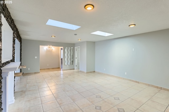 tiled empty room with a textured ceiling