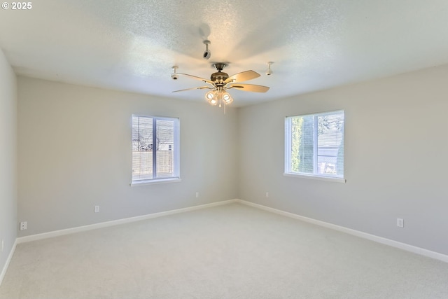 carpeted empty room featuring ceiling fan and a textured ceiling