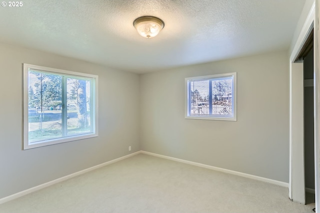 unfurnished bedroom featuring a closet, light carpet, and a textured ceiling