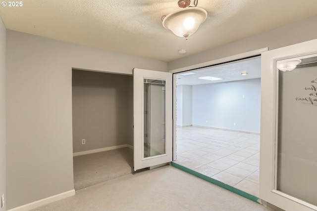 unfurnished room with carpet floors and a textured ceiling