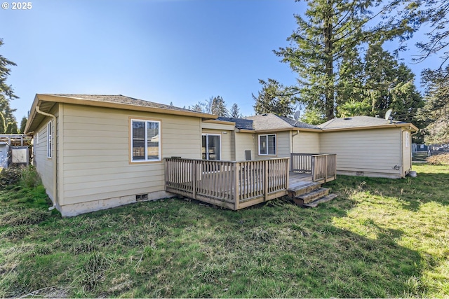 back of property with a wooden deck and a yard