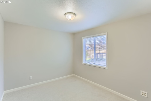 carpeted empty room with a textured ceiling