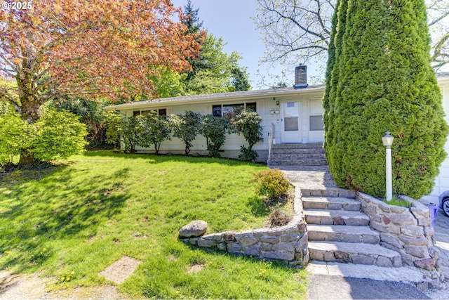 single story home with entry steps, a chimney, and a front lawn
