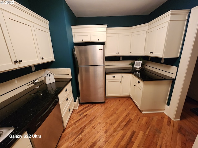 kitchen featuring white cabinetry, light wood-type flooring, and stainless steel appliances