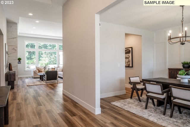 dining room with an inviting chandelier and hardwood / wood-style flooring