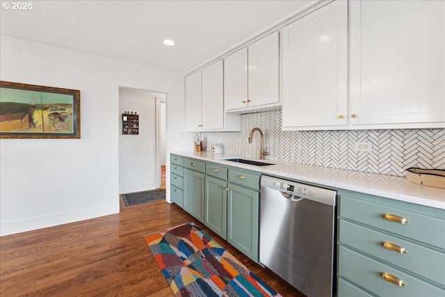 kitchen featuring white cabinetry, sink, backsplash, dark hardwood / wood-style flooring, and stainless steel dishwasher