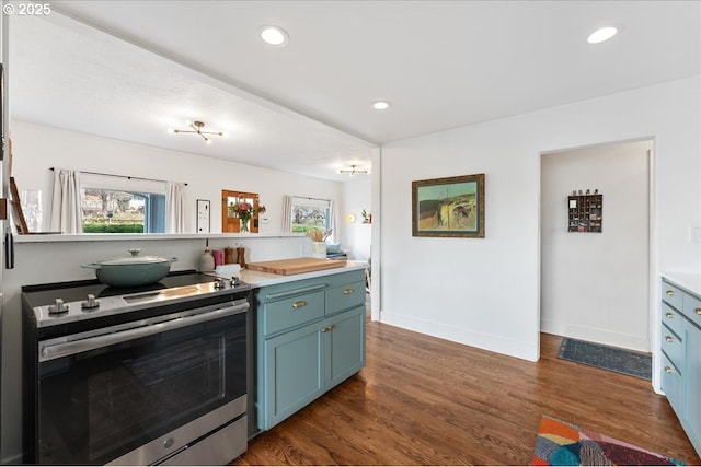 kitchen with electric range, plenty of natural light, blue cabinetry, and dark wood-type flooring