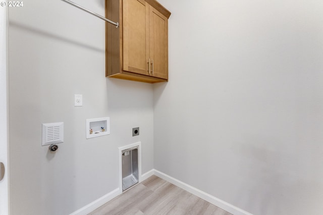 clothes washing area featuring cabinets, light wood-type flooring, electric dryer hookup, and hookup for a washing machine