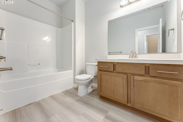 full bathroom featuring bathing tub / shower combination, vanity, toilet, and hardwood / wood-style flooring