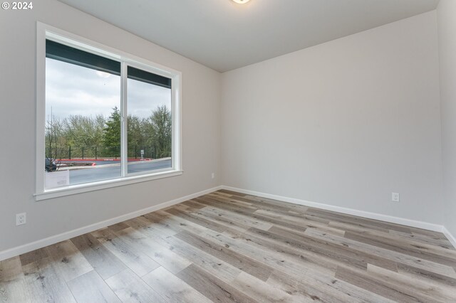 spare room with light hardwood / wood-style flooring