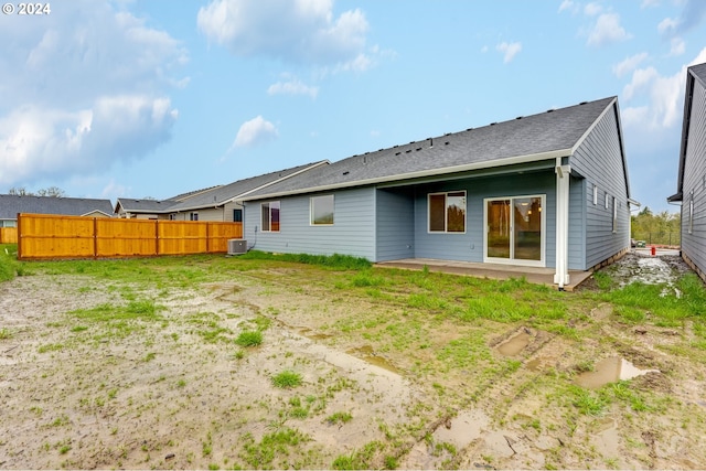 rear view of property with a patio area and central air condition unit