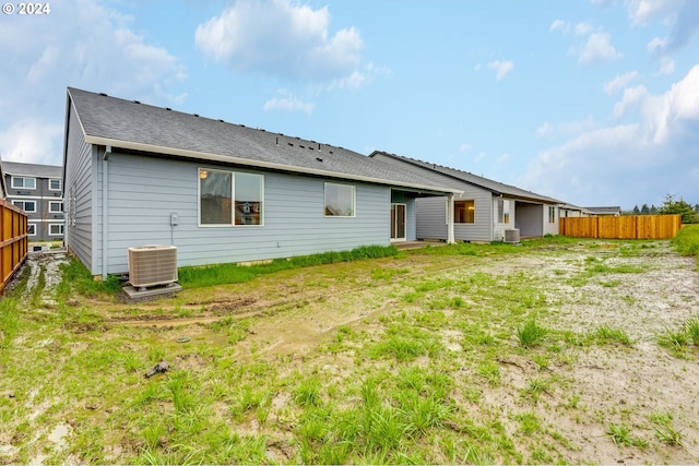 rear view of property featuring central AC unit