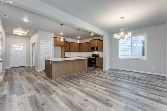 kitchen with a wealth of natural light, light hardwood / wood-style floors, and appliances with stainless steel finishes