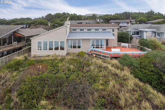 back of property featuring fence and a wooden deck