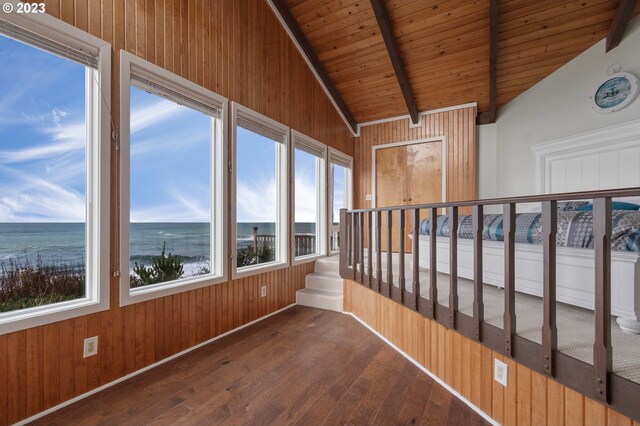 living room with beamed ceiling, high vaulted ceiling, wood walls, a fireplace, and wood ceiling