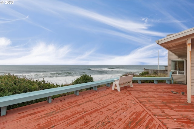 deck with a water view and a beach view