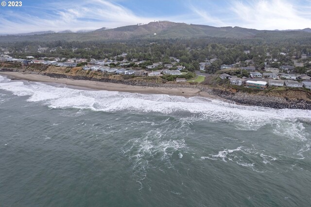 drone / aerial view featuring a water and mountain view