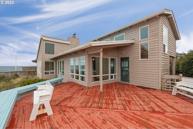 sunroom with vaulted ceiling with beams, a water view, ceiling fan, and wooden ceiling