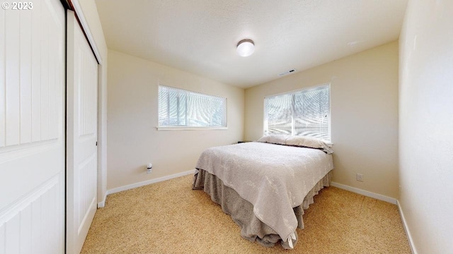 carpeted bedroom with a closet