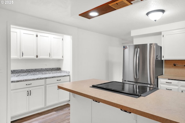 25191 Berry Ln, Veneta, OR 97487 - kitchen featuring freestanding refrigerator, cooktop, light countertops, white cabinetry, and recessed lighting
