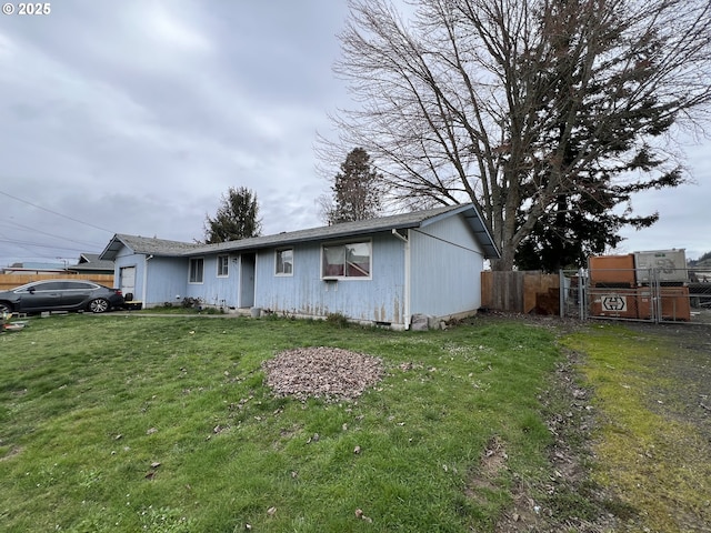 ranch-style house with a garage, fence, and a front yard