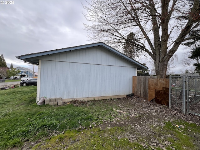 view of home's exterior featuring fence and a yard