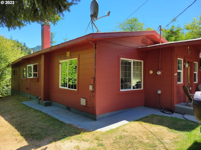 view of property exterior featuring a lawn