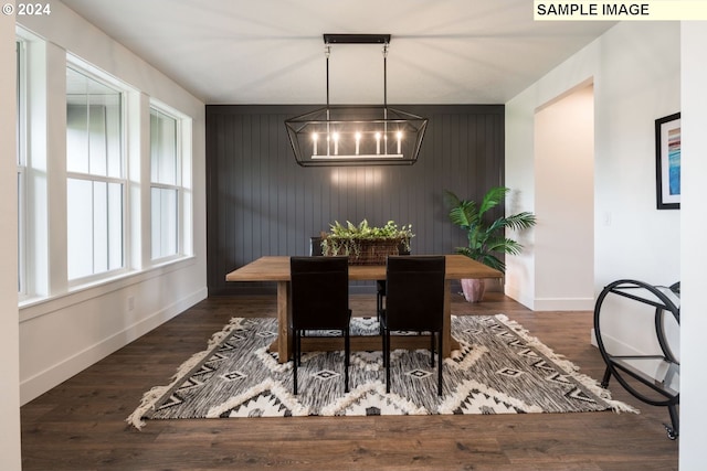 dining space featuring a chandelier and dark wood-type flooring