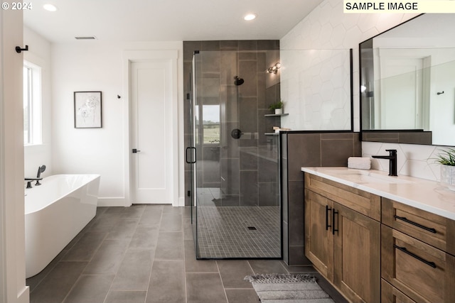 bathroom featuring tile walls, tile flooring, separate shower and tub, and vanity