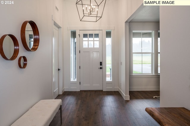 entryway with a notable chandelier and dark wood-type flooring