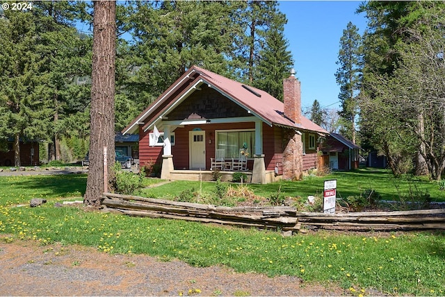 view of front of home with a porch and a front lawn