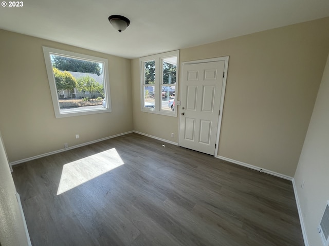 spare room with dark hardwood / wood-style flooring