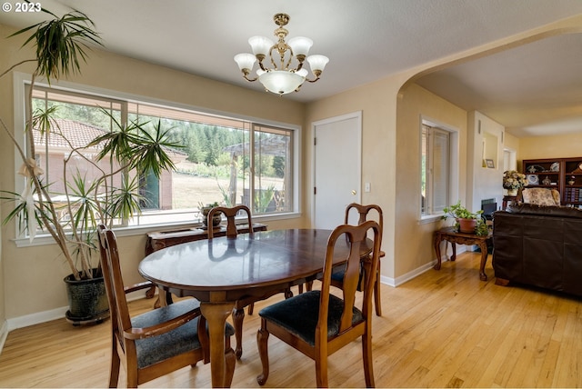 dining room with a chandelier and light wood-type flooring