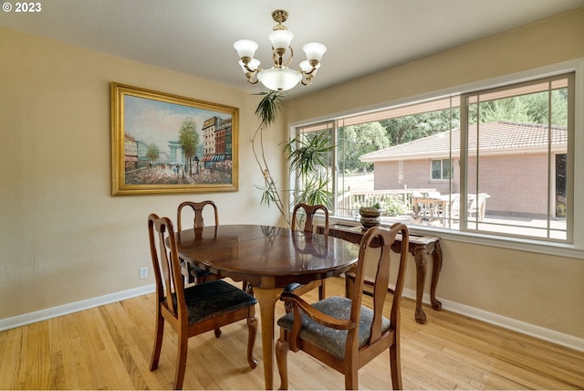 dining space with a chandelier and light wood-type flooring