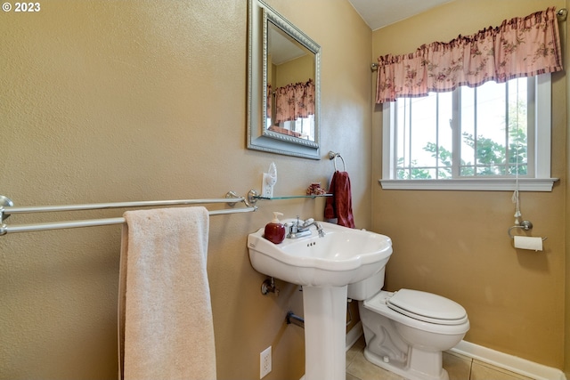 bathroom with toilet and tile flooring