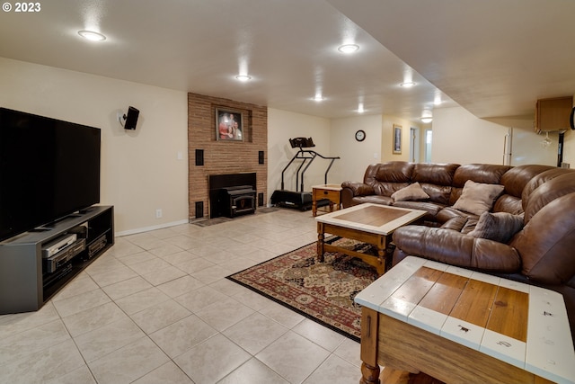 living room with a fireplace, brick wall, and light tile floors