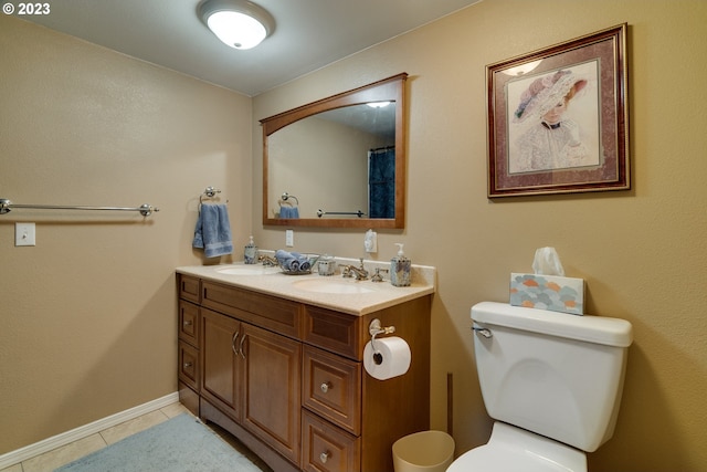 bathroom with toilet, tile floors, and vanity